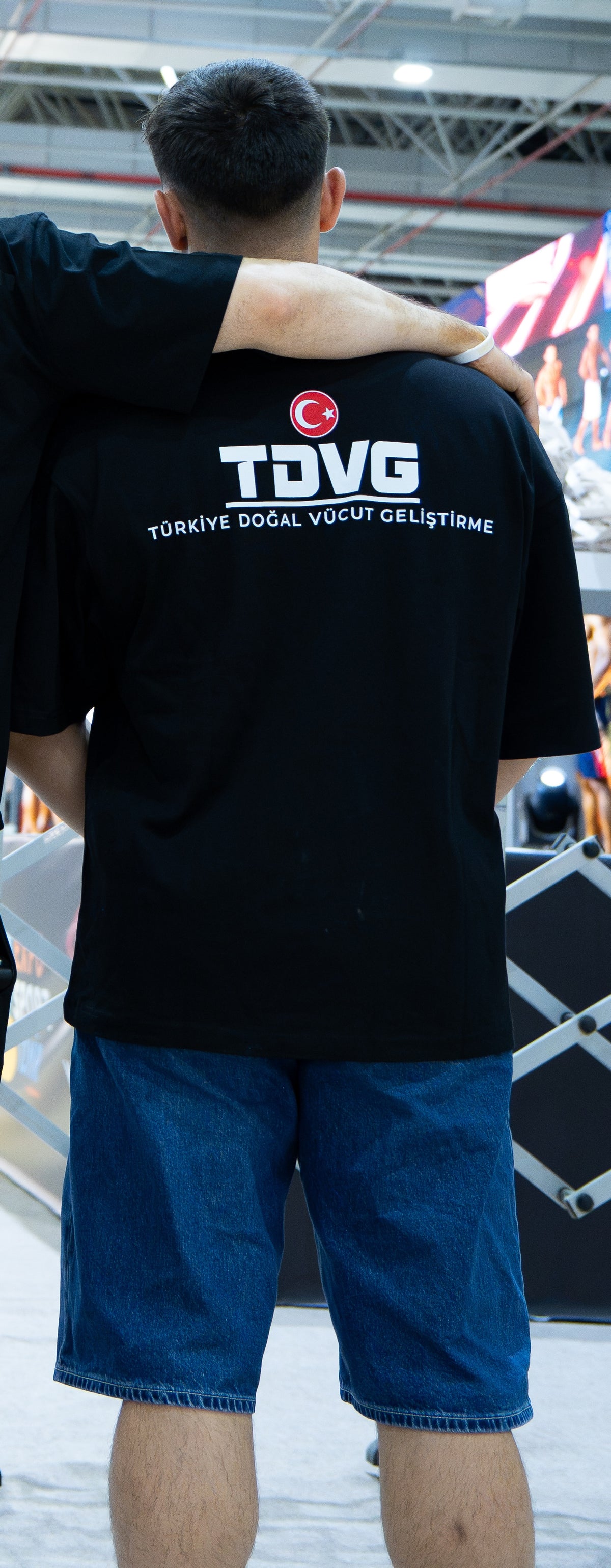 DOĞAL. 002 × TDVG tişört — gerçek etkinlik fotoğrafı, orijinal TDVG sırt baskısı